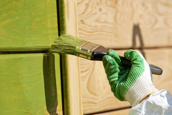 Painter in Monument, CO painting wood green