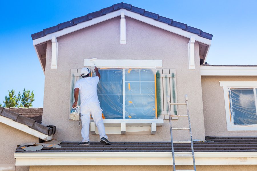 home painter painting the exterior of a home in Colorado Springs